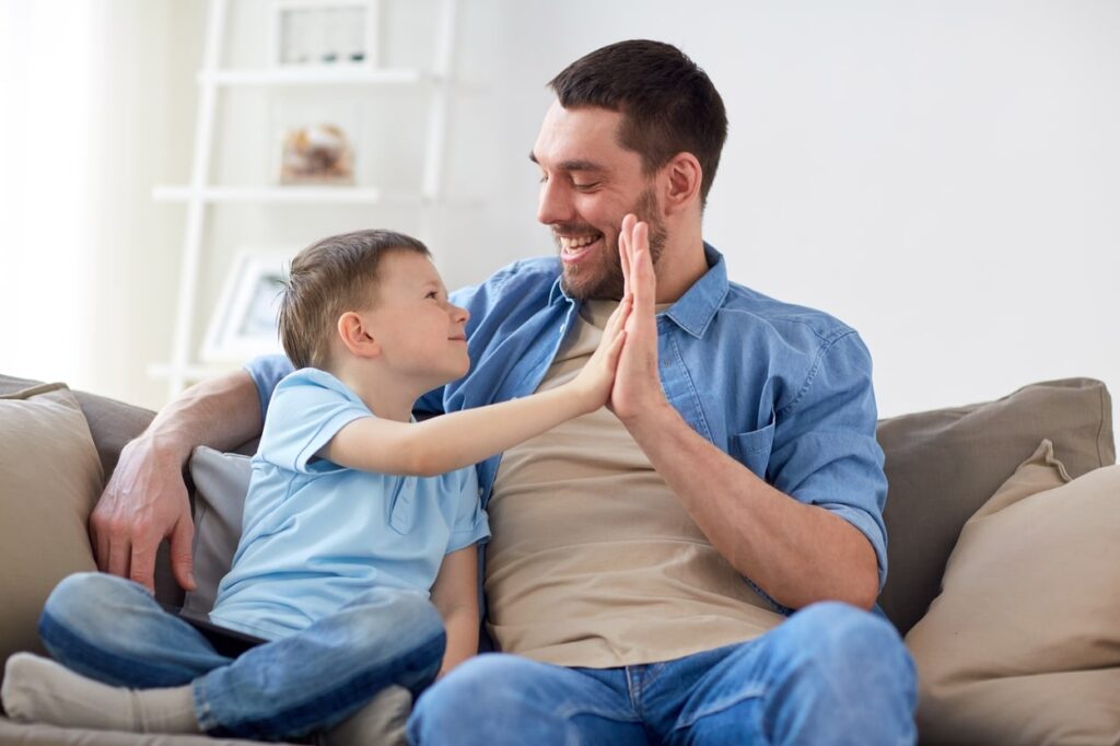 Help Your Child Achieve Success! *Father and son giving each other five in celebration*