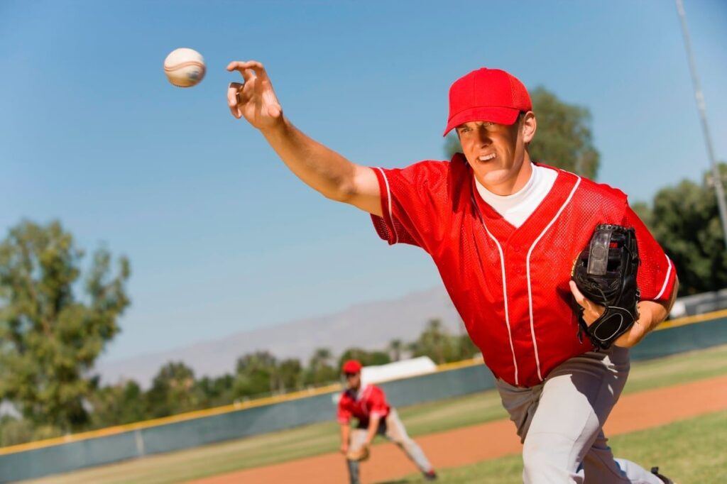 Adult baseball pitcher throwing a baseball
