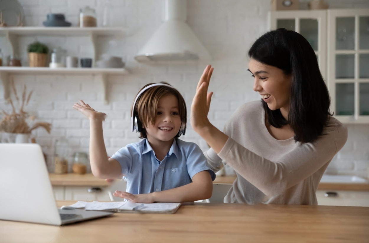 mom and son working together on brainbeat clapping hands on success